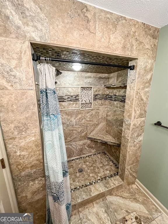 bathroom featuring a textured ceiling and walk in shower