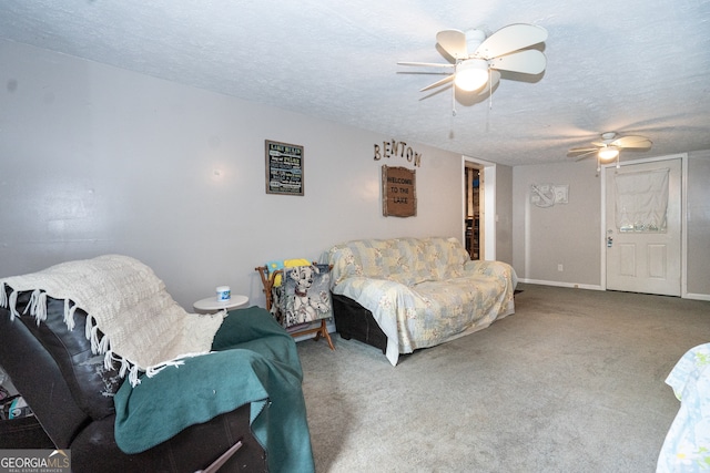 living room with ceiling fan, a textured ceiling, and carpet floors