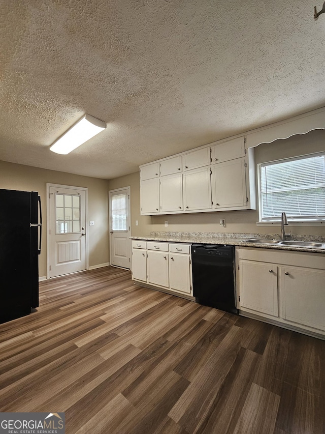 kitchen with sink, dark wood-type flooring, a textured ceiling, white cabinets, and black appliances