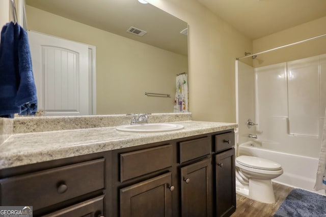 full bathroom featuring vanity, toilet, hardwood / wood-style floors, and shower / bathtub combination with curtain