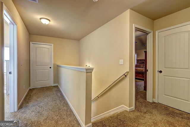 1223 Hartwell Rd, Locust Grove, GA 30248 - hallway featuring baseboards, an upstairs landing, and carpet floors