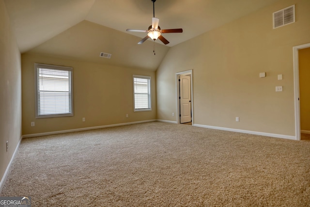 carpeted empty room with high vaulted ceiling, ceiling fan, and a wealth of natural light