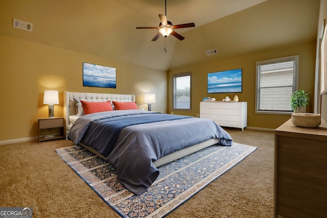 carpeted bedroom with ceiling fan and vaulted ceiling