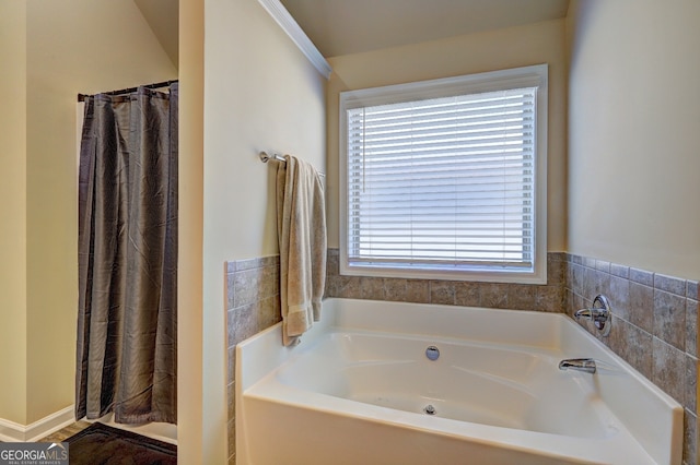 bathroom featuring shower with separate bathtub