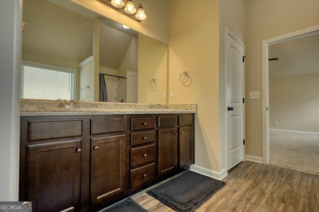 1223 Hartwell Rd, Locust Grove, GA 30248 - bathroom with double vanity, wood finished floors, baseboards, and a sink