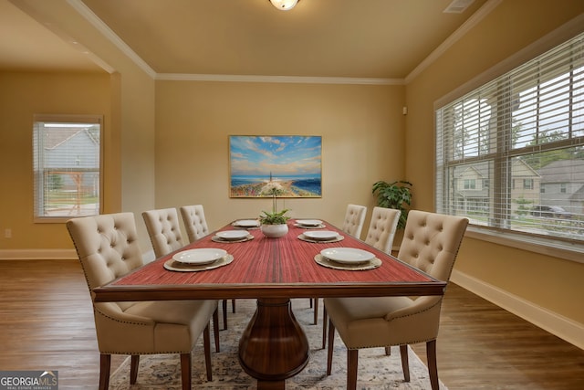 dining room featuring ornamental molding and dark hardwood / wood-style floors