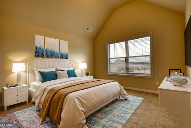 bedroom featuring carpet and vaulted ceiling