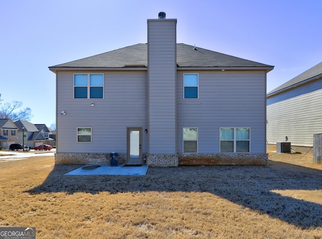 rear view of property with a yard, central AC, and a patio