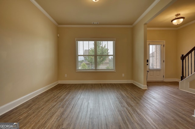 foyer featuring dark hardwood / wood-style floors and crown molding