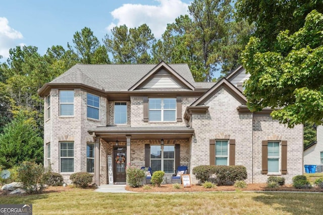 view of front of property with a front yard and covered porch