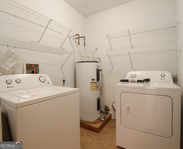 washroom with washer and dryer and water heater