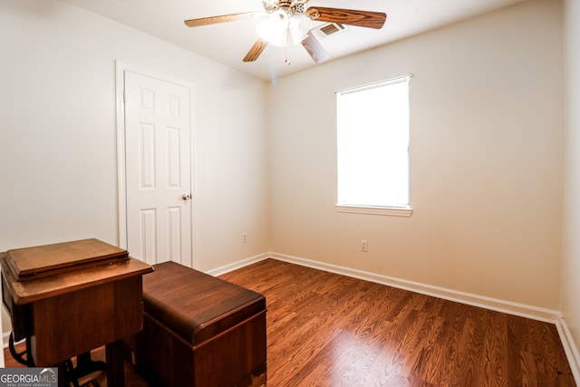 interior space featuring ceiling fan and dark hardwood / wood-style floors