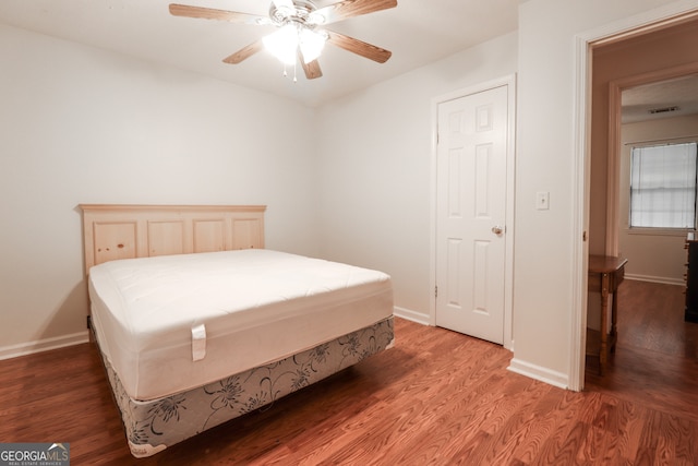 bedroom with wood-type flooring and ceiling fan