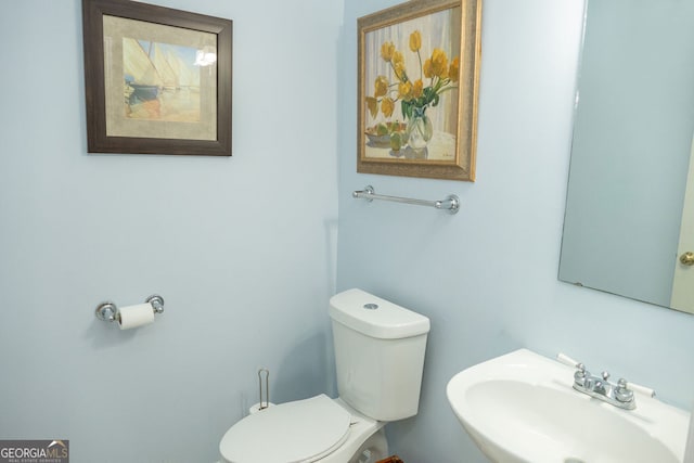 bathroom with toilet and sink