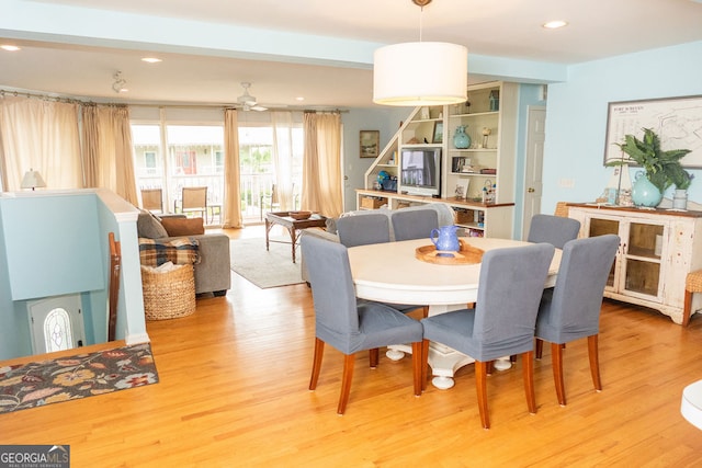 dining space with light hardwood / wood-style floors and ceiling fan