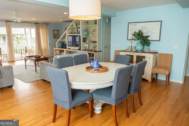 dining space with light hardwood / wood-style floors and ceiling fan