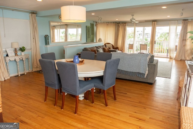 dining room featuring ceiling fan, light hardwood / wood-style floors, and a healthy amount of sunlight