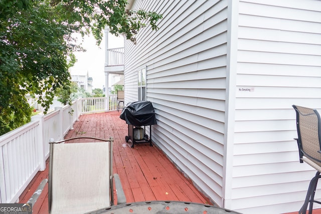 wooden deck featuring area for grilling