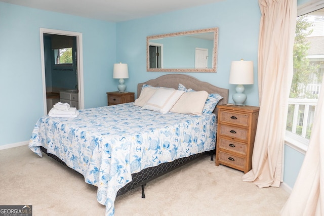 carpeted bedroom with ensuite bathroom