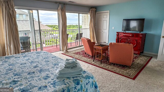 carpeted bedroom featuring access to exterior