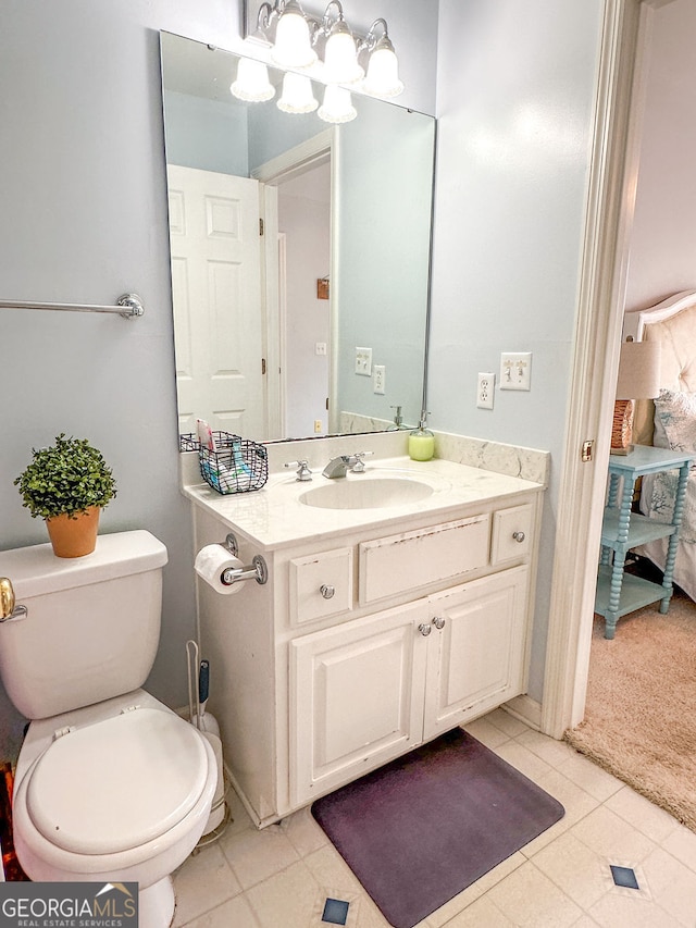 bathroom with tile patterned floors, vanity, and toilet