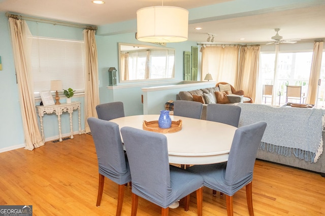 dining space featuring ceiling fan and light wood-type flooring