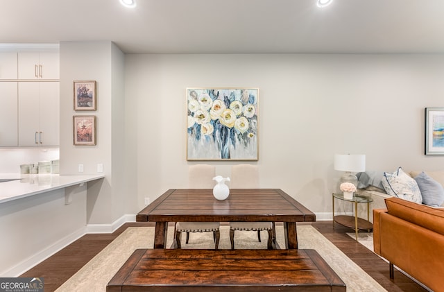 dining space with dark wood-type flooring