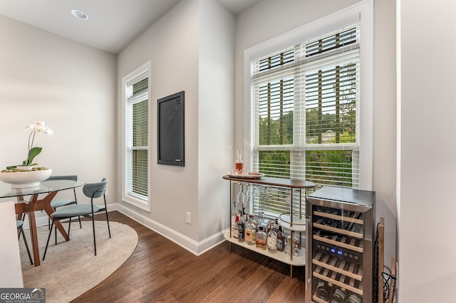 home office with wine cooler and dark hardwood / wood-style floors