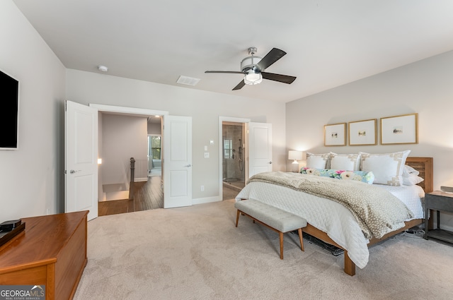 bedroom with carpet, ensuite bath, and ceiling fan