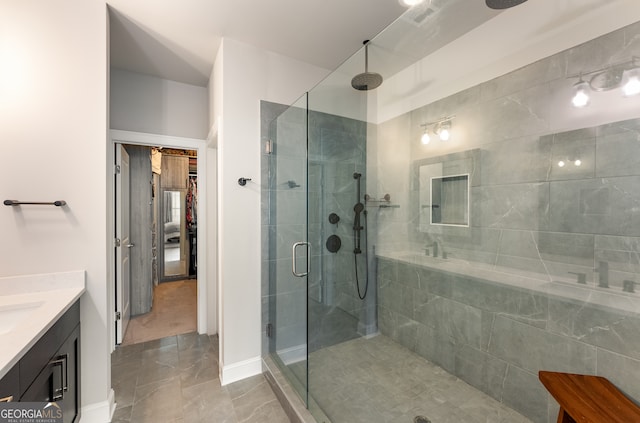 bathroom featuring walk in shower and vanity