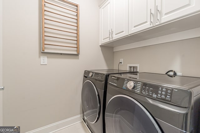 clothes washing area featuring cabinets, light tile patterned floors, and separate washer and dryer