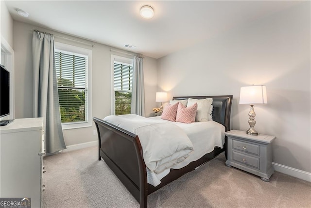 bedroom featuring light colored carpet