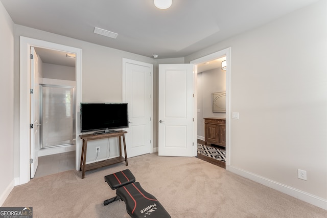 exercise area featuring light colored carpet