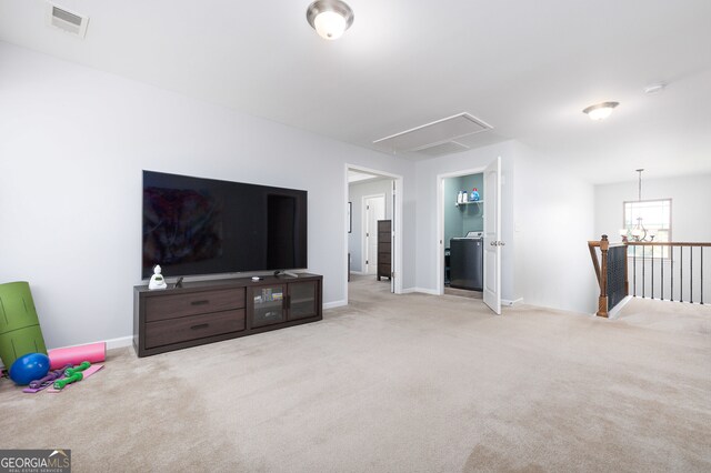 carpeted living room featuring a notable chandelier