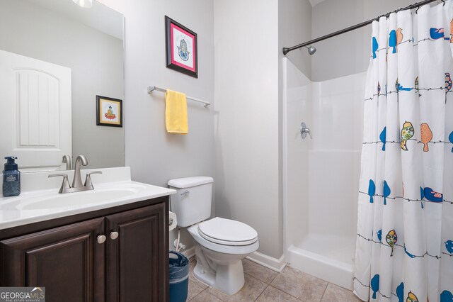 bathroom featuring a shower with curtain, vanity, toilet, and tile patterned floors