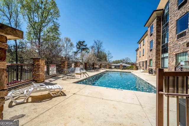 view of swimming pool with a patio