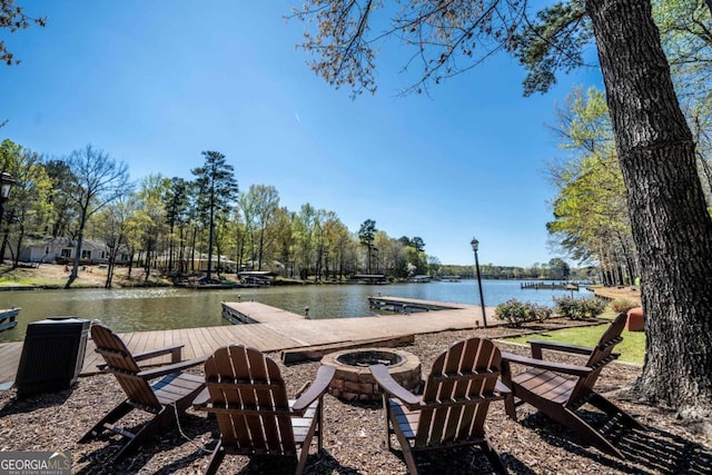 view of pool with a water view and an outdoor fire pit