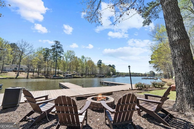 dock area featuring a water view and a fire pit