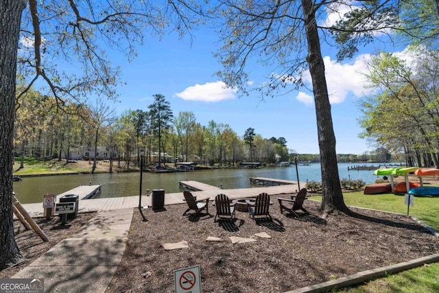 exterior space with a water view and a dock