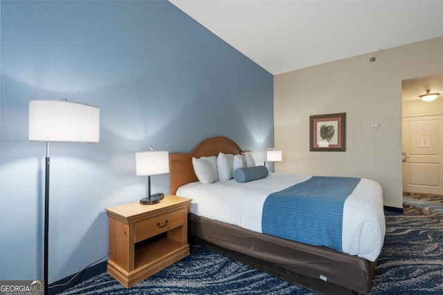 carpeted bedroom featuring vaulted ceiling