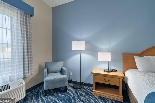 carpeted bedroom with a wall mounted air conditioner