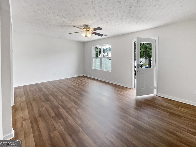 spare room featuring a textured ceiling, ceiling fan, and dark hardwood / wood-style floors