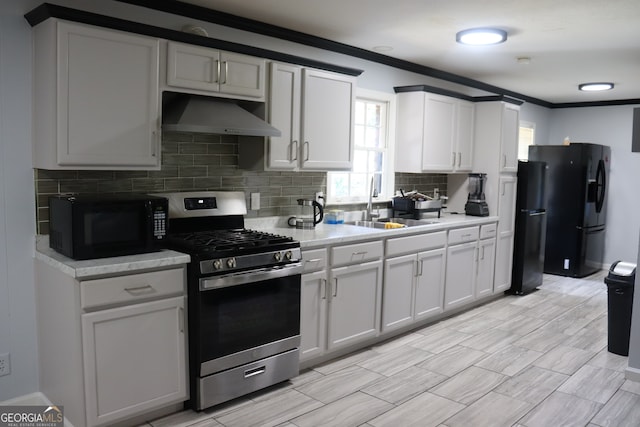 kitchen with crown molding, white cabinetry, sink, black appliances, and extractor fan