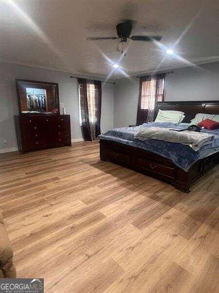 bedroom with ceiling fan and light hardwood / wood-style floors