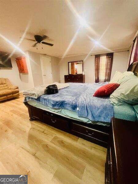 bedroom with hardwood / wood-style flooring and ceiling fan