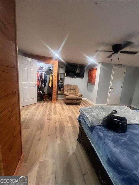 bedroom with a closet, ceiling fan, and hardwood / wood-style flooring