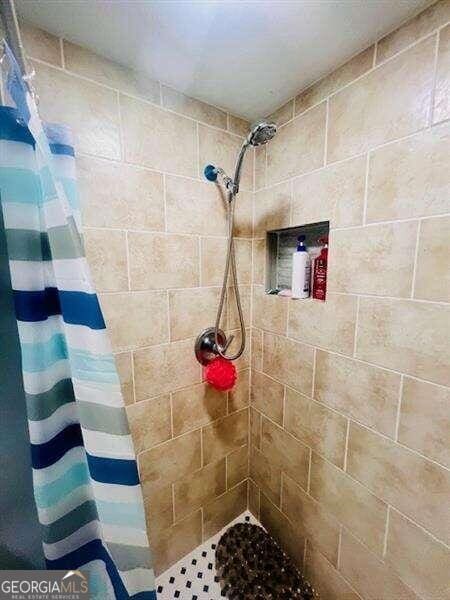 bathroom with a shower with shower curtain