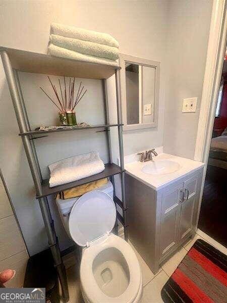 bathroom with vanity, toilet, and tile patterned flooring