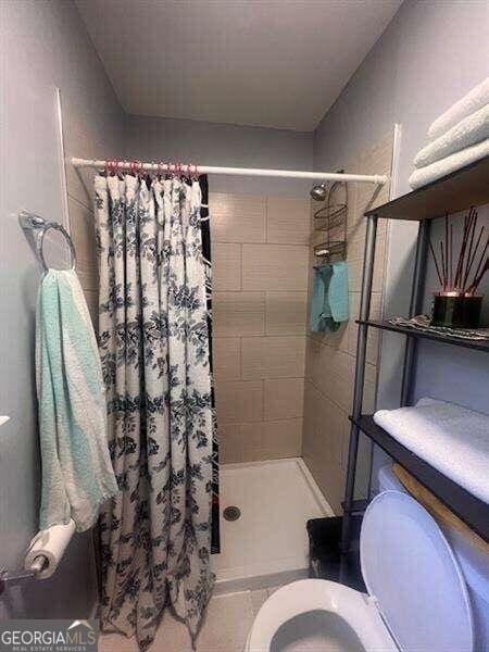 bathroom featuring toilet and walk in shower