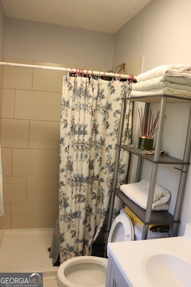 bathroom with vanity, toilet, and a shower with curtain